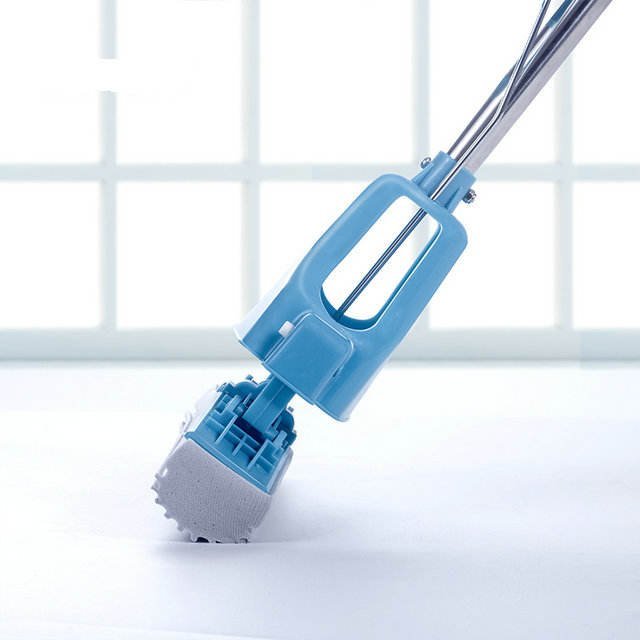 Side view of the blue sponge mop hood with the grey PVA sponge head on the floor