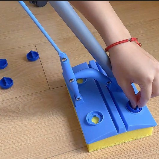 Hand turning a blue twist cap that holds the cellulose sponge to the mop head