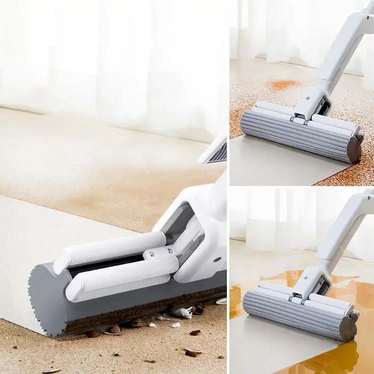 White double-roller sponge mop picking up grit and a liquid spill on a hard floor