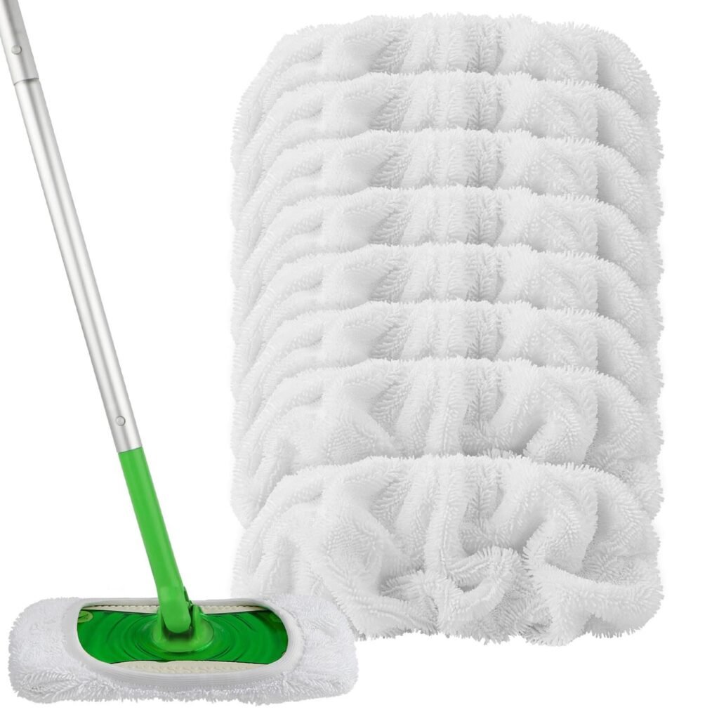 Stack of white slip-on mop covers beside a sweeper mop fitted with one