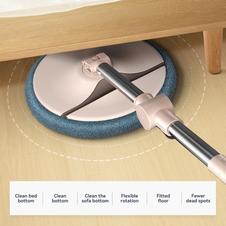 Round microfiber mop head sliding under a wooden bed frame on a light floor