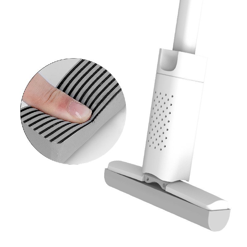 Ribbed grey sponge of the handheld mini squeeze mop pressed with a finger