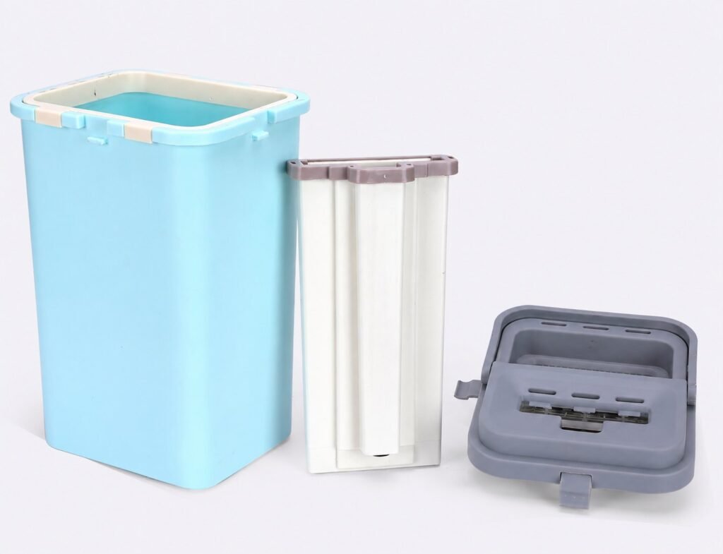 Mop bucket taken apart into light blue outer bucket, white inner liner and grey lid