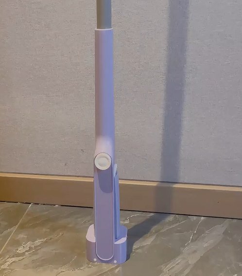Lilac mini mop standing on its own with the head folded into the sleeve