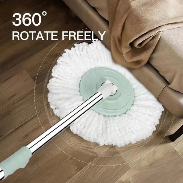 Round microfiber head of the mint spin mop swivelling 360 degrees beside a sofa