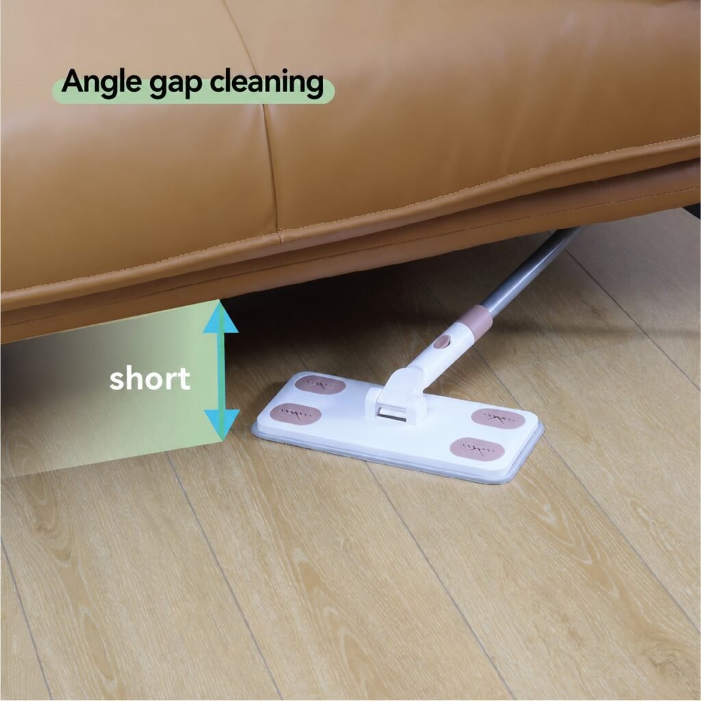 Press-in grip flat mop reaching under a low leather sofa on a wooden floor
