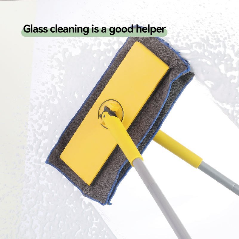 Yellow flat mop with grey cloth wiping a wet glass surface