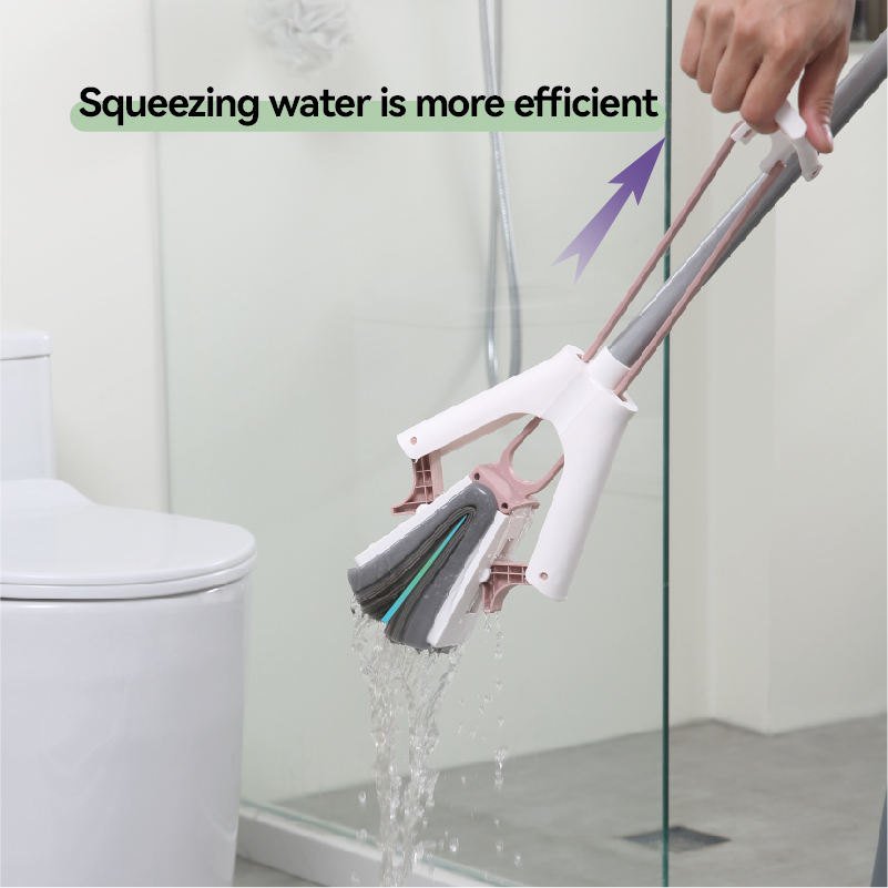 Hand lifting the pull handle so the sponge mop folds and wrings out water