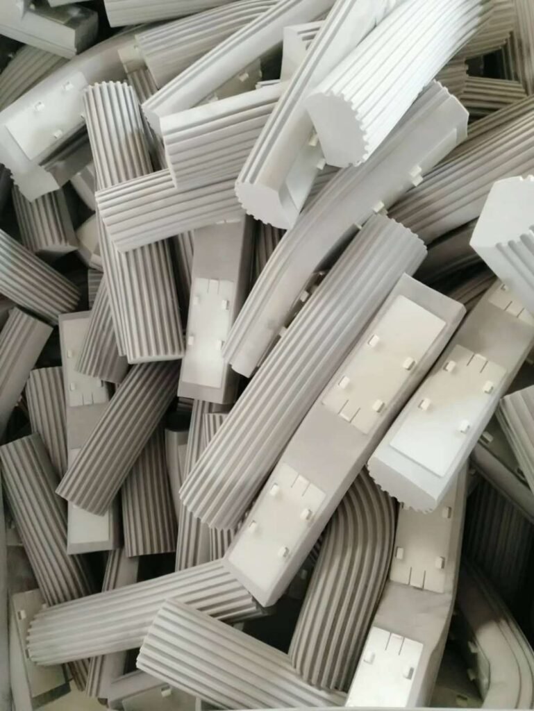 Pile of grey ribbed PVA sponge mop heads on the factory floor