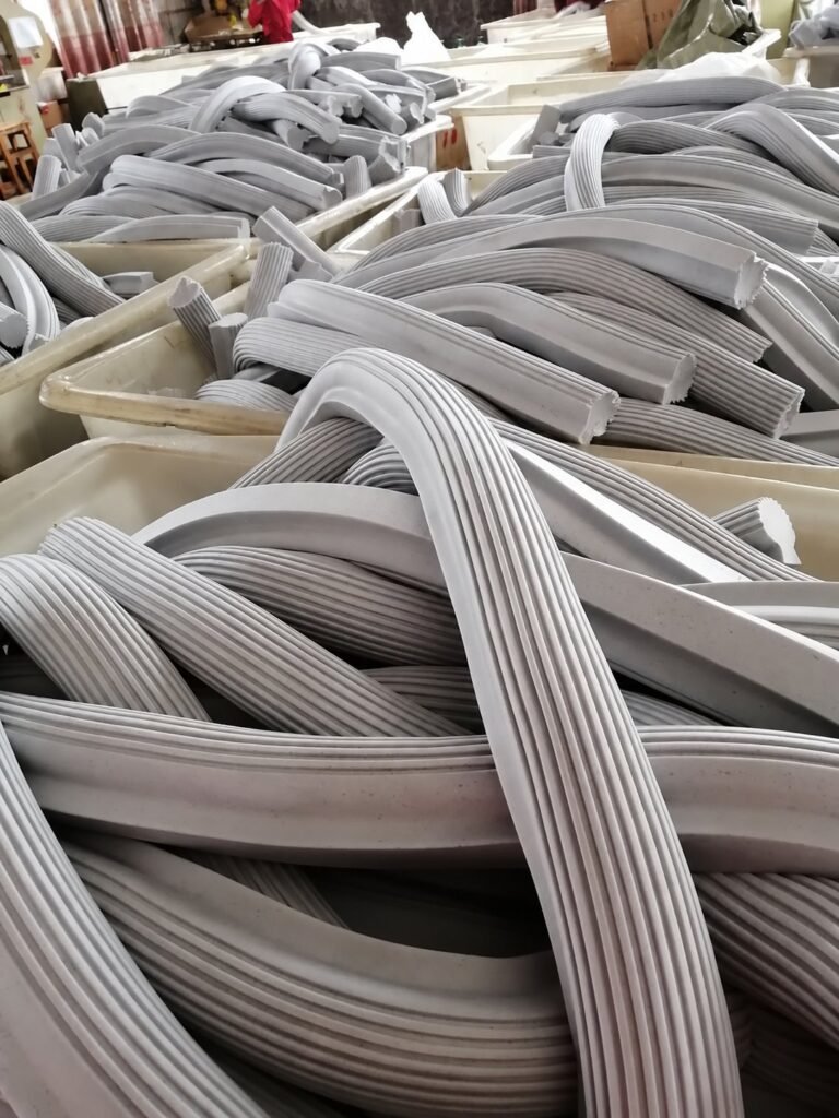 Long lengths of grey ribbed PVA sponge stock in factory crates