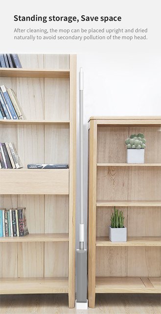 Sleeve-squeeze sponge mop standing upright between two bookshelves to dry