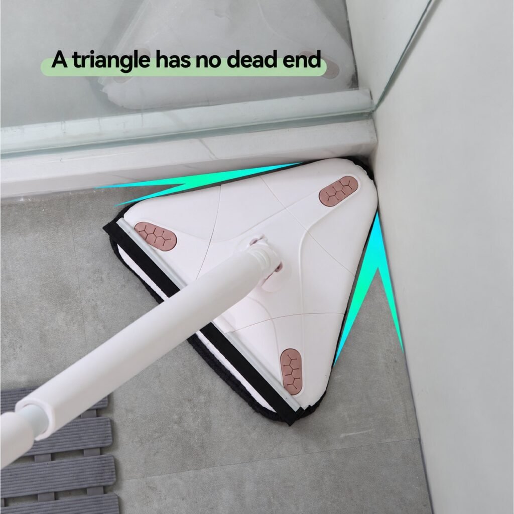 Point of the triangle mop head reaching into a bathroom floor corner beside a shower