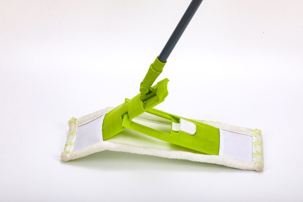 Green folding flat mop frame hinged at the centre slider inside a white microfiber pad