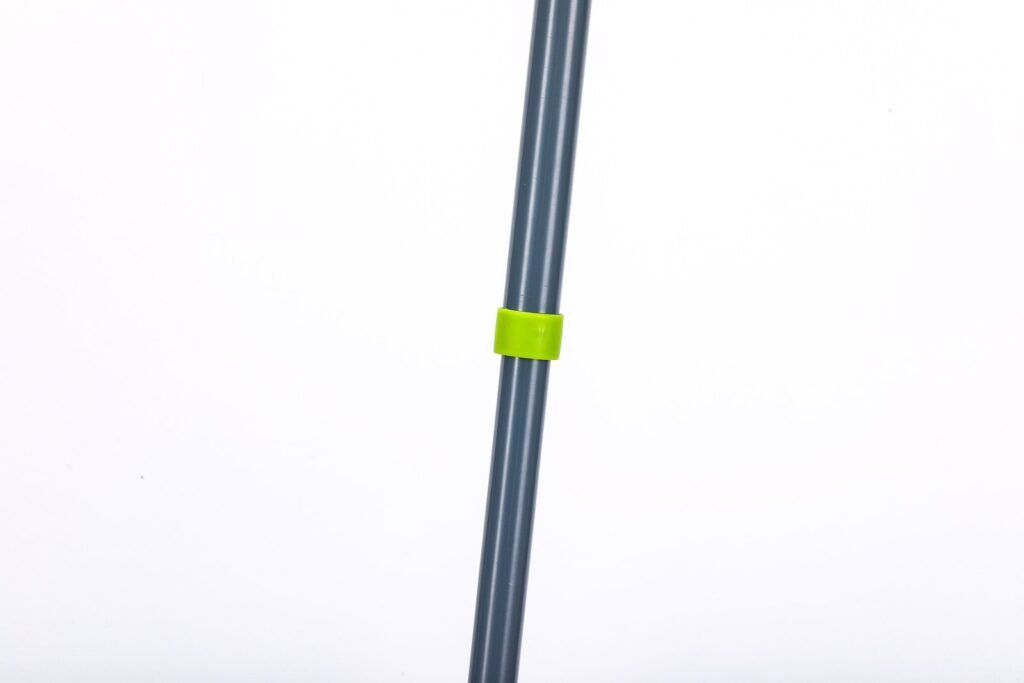 Grey metal pole of the folding flat mop with its green joining collar