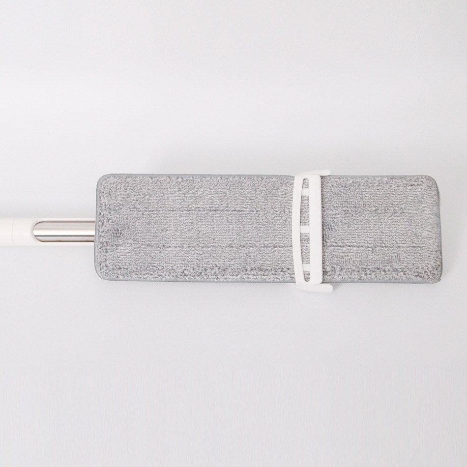 Microfiber pad of the squeeze spray flat mop held in its white sliding frame