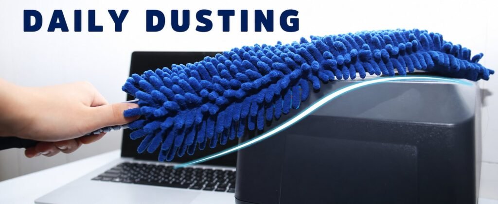 Bendable blue chenille fan duster curved over the top of a printer