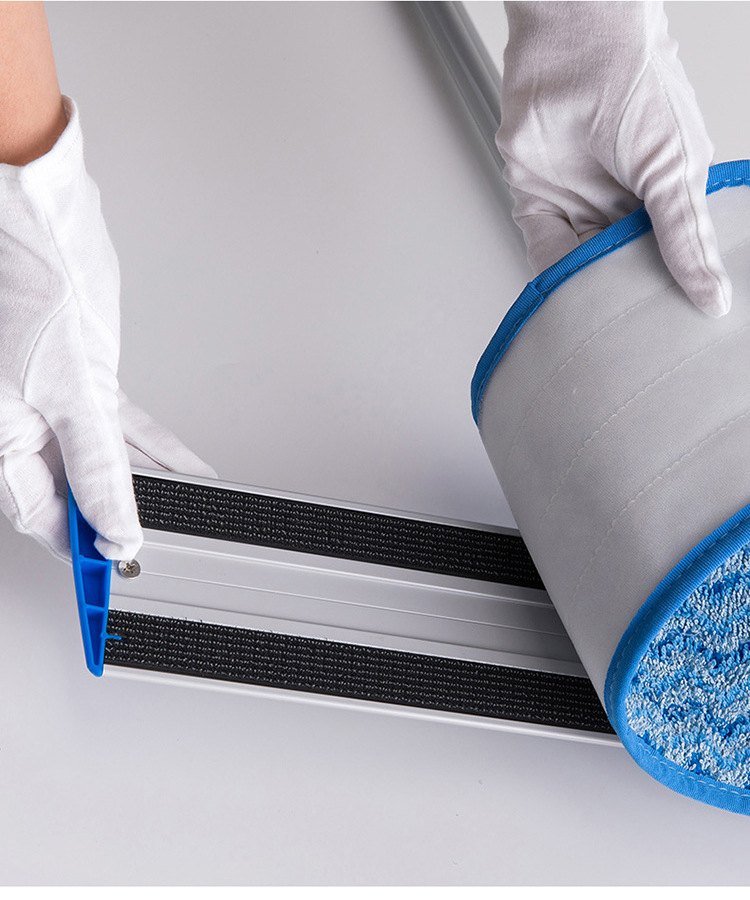 Gloved hands lifting the microfiber pad off the hook strips of a frame